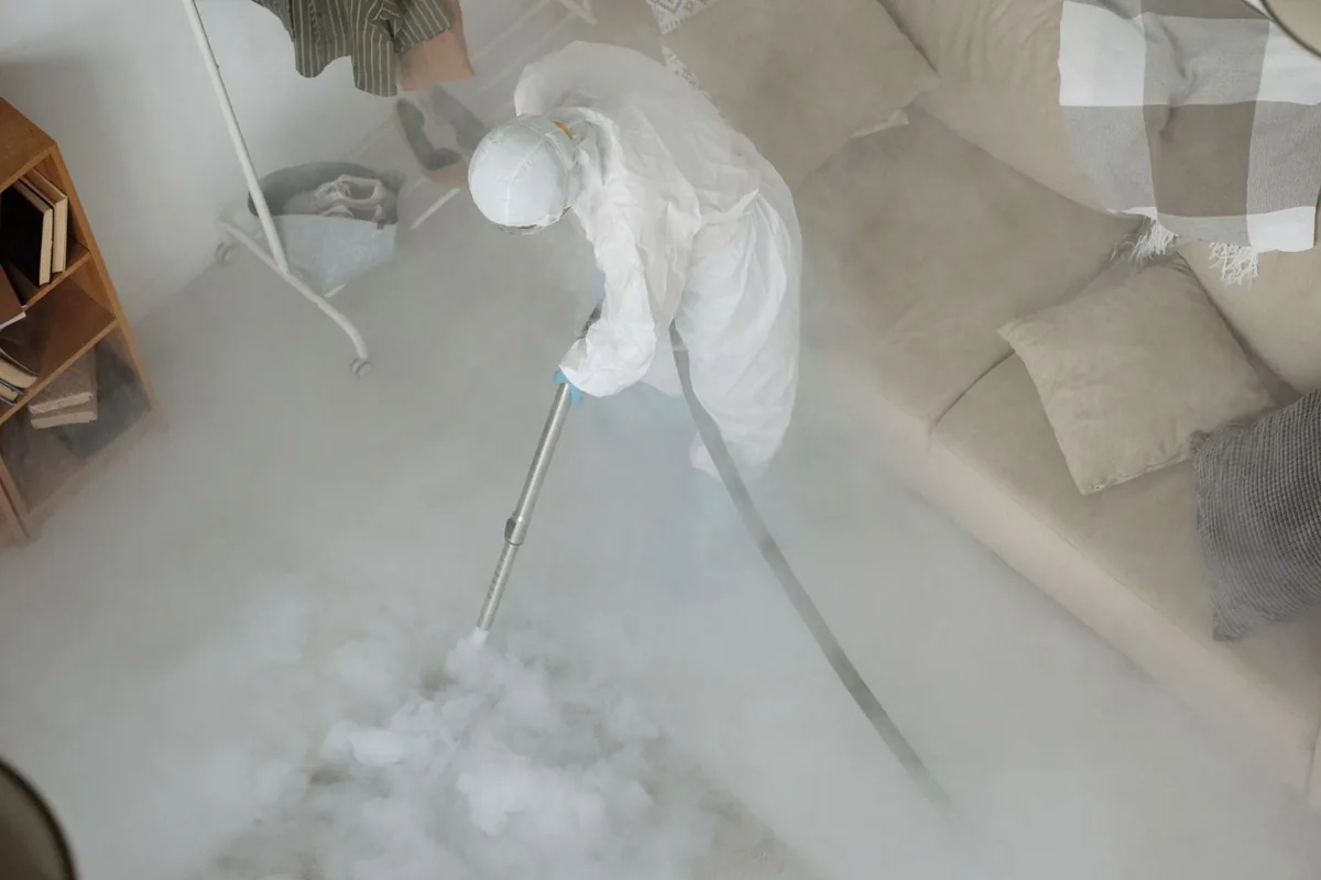 Biohazard cleanup technician in protective equipment, Hurst, TX